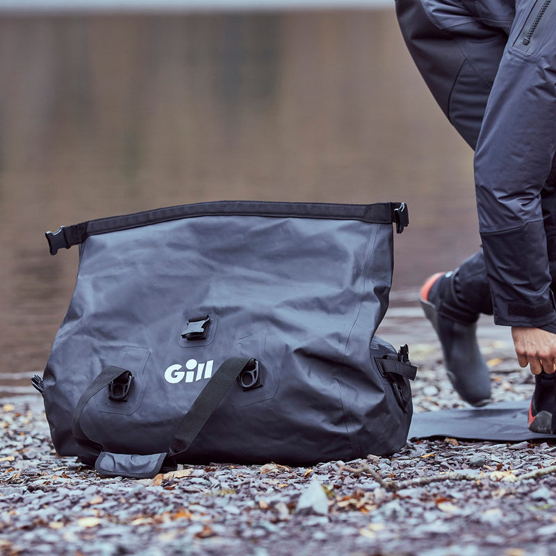 Lifestyle image of 60L Black Gill Duffel on shore
