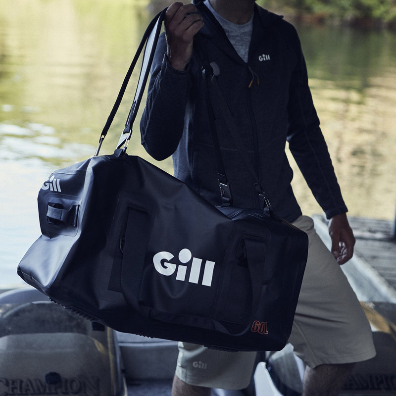 Lifestyle image of man carrying Gill duffel off boat