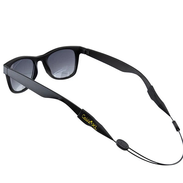 Black sunglasses with a black strap on a white background