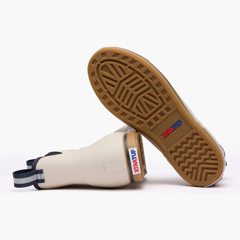 White rubber boot with brown sole on a white background