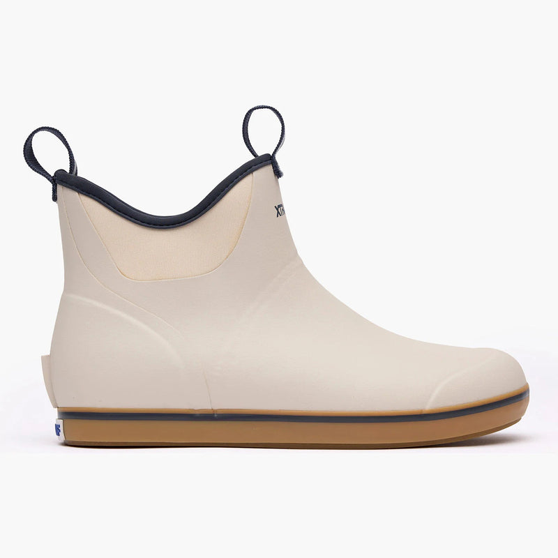 Beige rubber boot with black trim on a white background