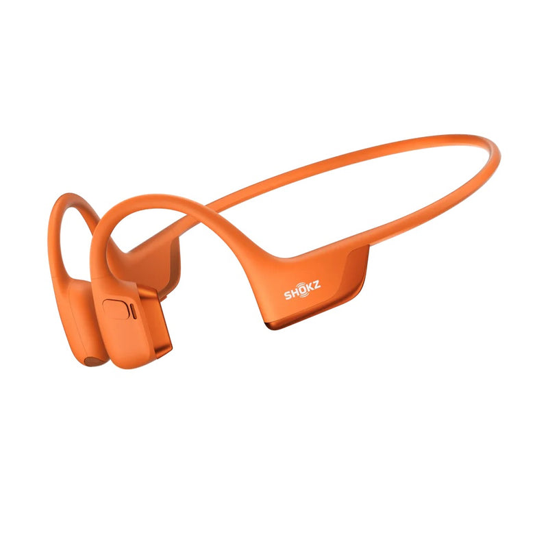 Orange Shokz bone conduction headphones on a white background