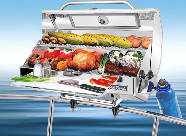Magma Monterey II Infrared Gas Grill mounted on rail with lid open showing food