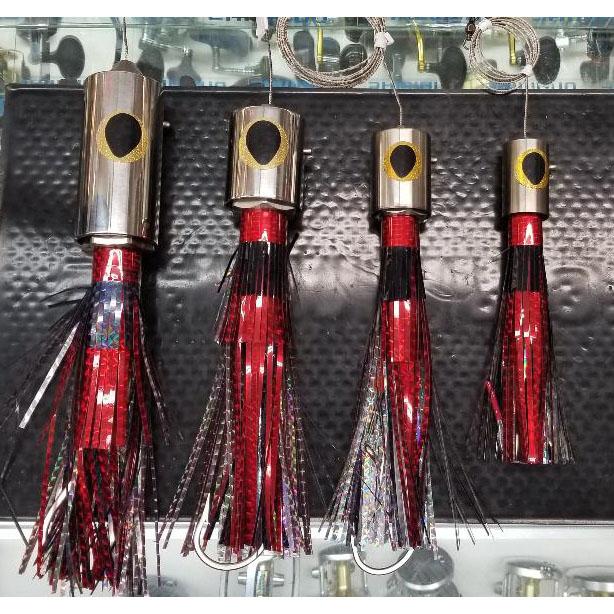 Four different size lures with chrome heads and red and black skirts