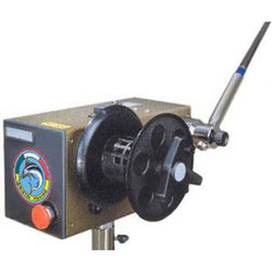 Rectangle, stainless steel casing for the motor. Red button shown as well as empty spool on right side. Rod base shown as well.