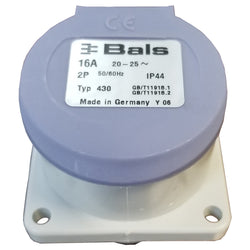 Small cylinder shaped electric plug with square base. Purple lid with label stating 16 AMP.