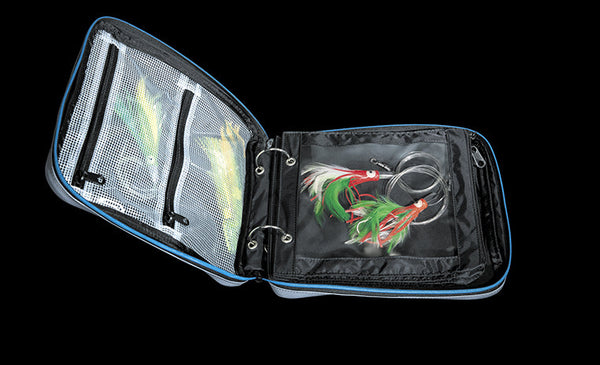 binder open showing zippered compartments with lures inside